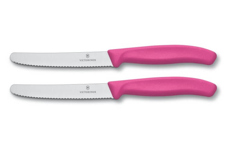 2 couteaux de table Victorinox lame 11cm à dents bout rond manche rose